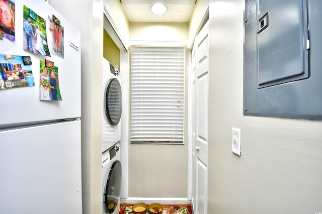 washroom with stacked washing maching and dryer