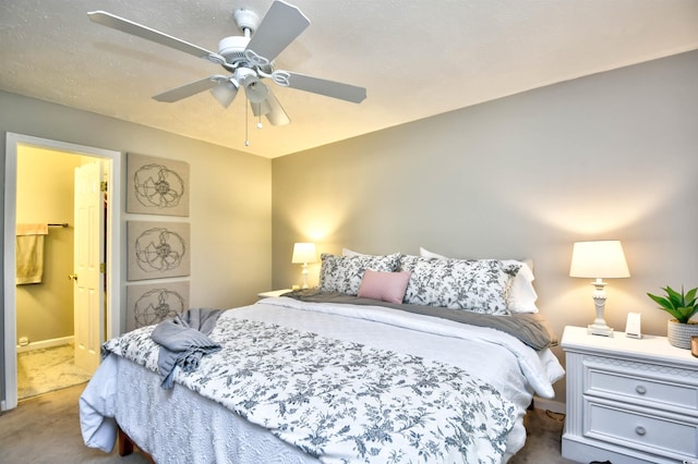 carpeted bedroom featuring a textured ceiling, ceiling fan, and connected bathroom