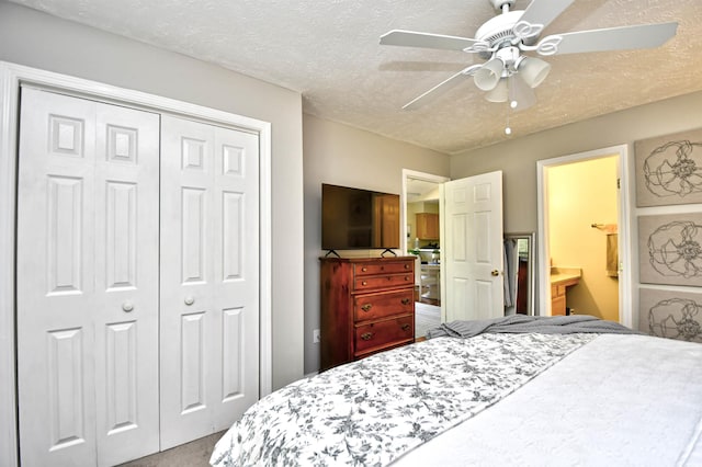 bedroom with ensuite bath, ceiling fan, a textured ceiling, and a closet