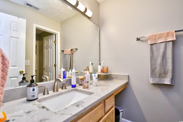 bathroom featuring vanity and a textured ceiling