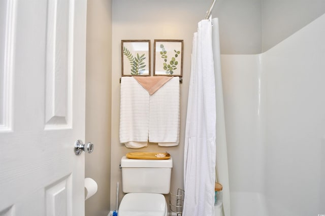 bathroom featuring walk in shower and toilet