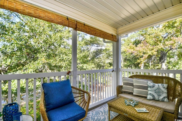 sunroom / solarium featuring plenty of natural light and wood ceiling