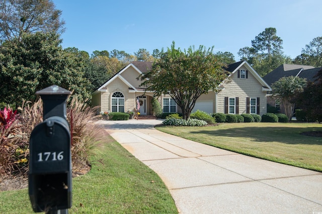 view of front of house with a garage and a front yard