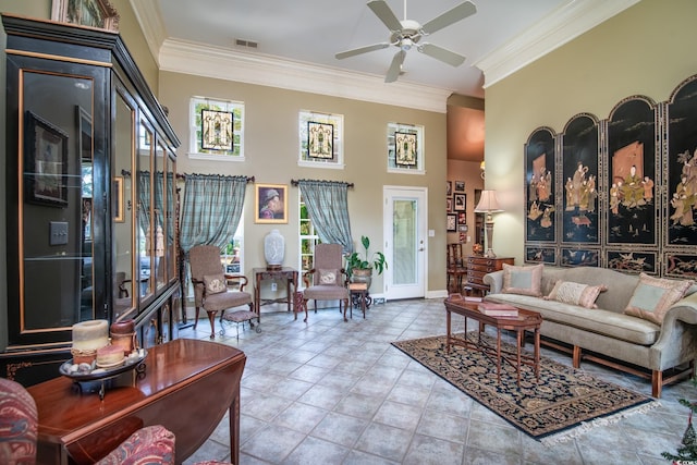 living room featuring ceiling fan and crown molding