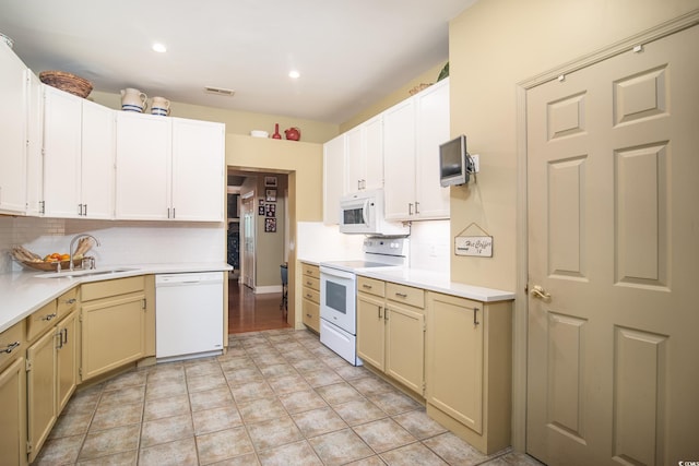 kitchen with light tile patterned floors, white appliances, sink, and tasteful backsplash