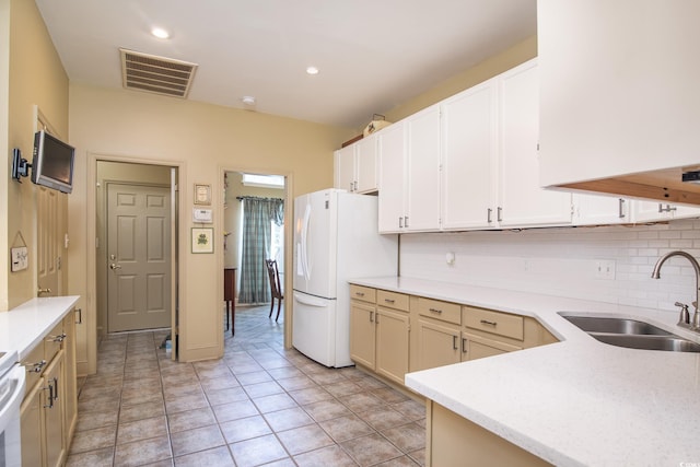 kitchen featuring decorative backsplash, sink, white fridge, and light tile patterned flooring