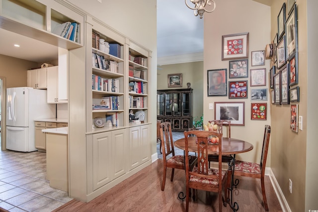 tiled dining space featuring crown molding