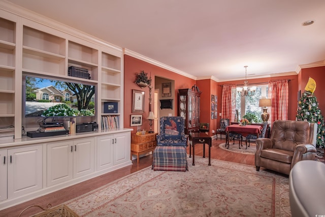 living room featuring ornamental molding, a chandelier, and light hardwood / wood-style floors