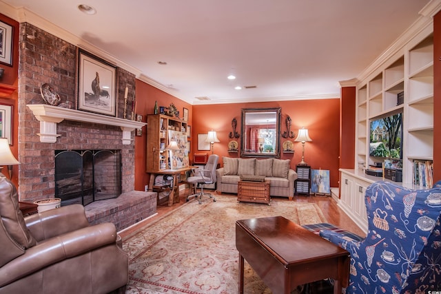 living room featuring a brick fireplace, light hardwood / wood-style flooring, and crown molding