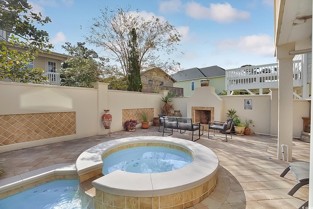 view of pool with an in ground hot tub and a patio area