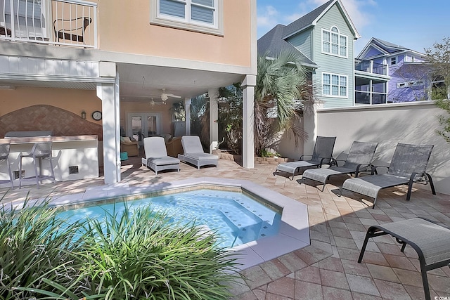 view of swimming pool with a patio and ceiling fan