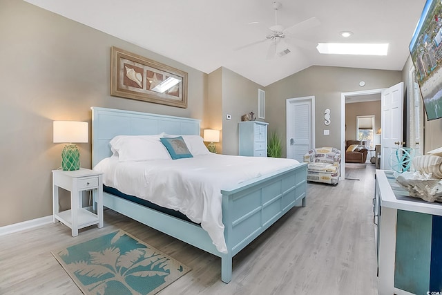 bedroom with a closet, vaulted ceiling, ceiling fan, and light hardwood / wood-style flooring