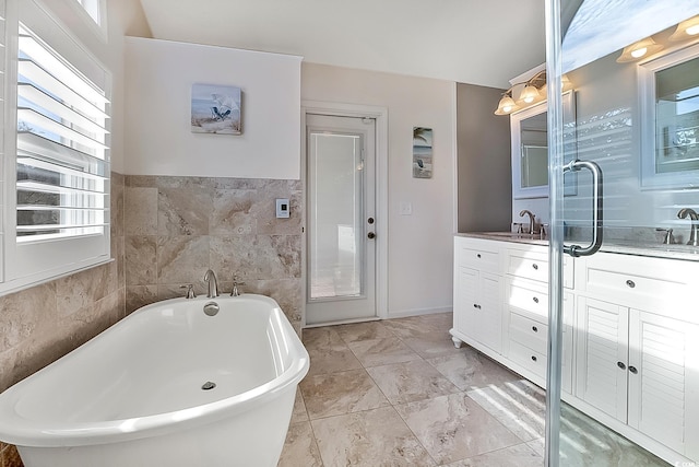 bathroom with a bathing tub and vanity