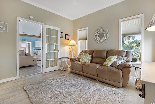 living room with crown molding and light hardwood / wood-style flooring