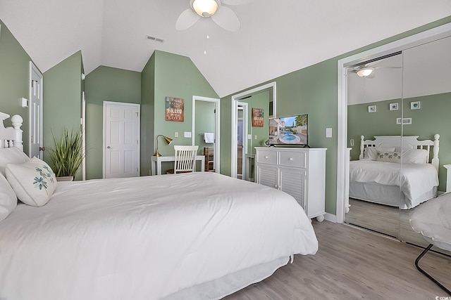 bedroom with light hardwood / wood-style floors, ceiling fan, and vaulted ceiling