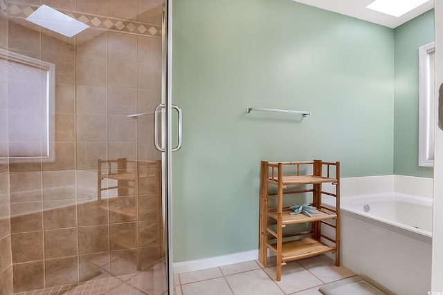 bathroom with tile patterned flooring, a skylight, and plus walk in shower