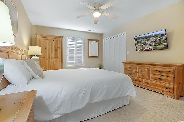 carpeted bedroom with a closet and ceiling fan