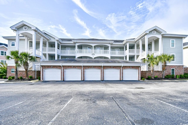 view of front of house featuring a garage and a balcony