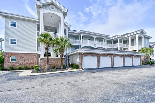 view of front of home featuring a garage and a balcony