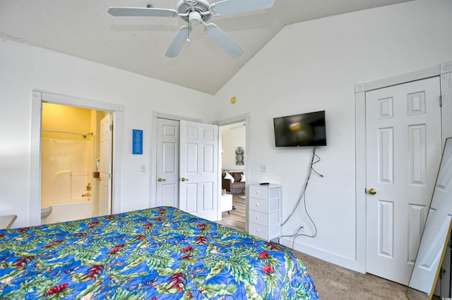 bedroom with ensuite bathroom, lofted ceiling, ceiling fan, and light carpet