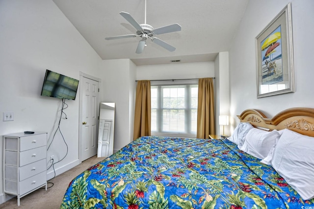 carpeted bedroom featuring ceiling fan and vaulted ceiling