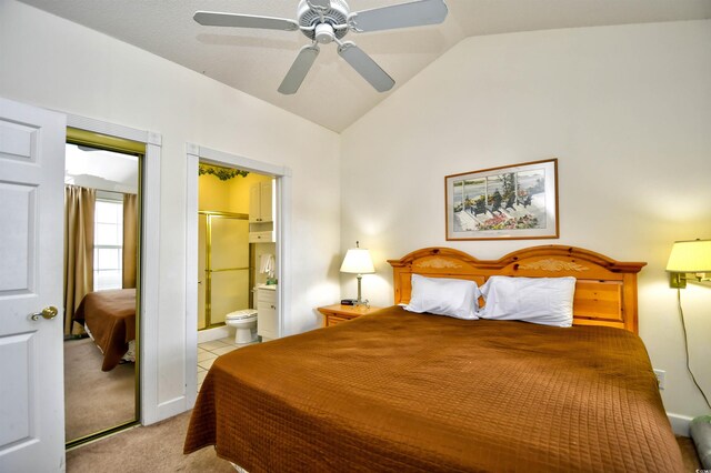 carpeted bedroom with ceiling fan, ensuite bath, and lofted ceiling