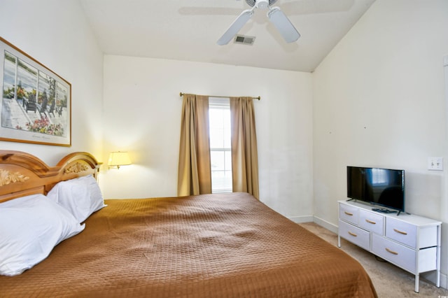 carpeted bedroom with ceiling fan and vaulted ceiling