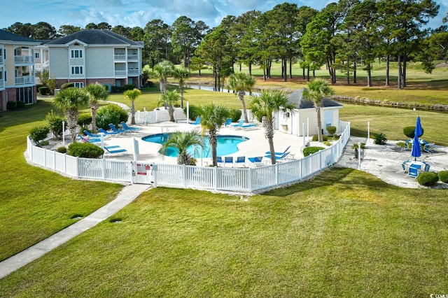 view of swimming pool with a yard and a patio area