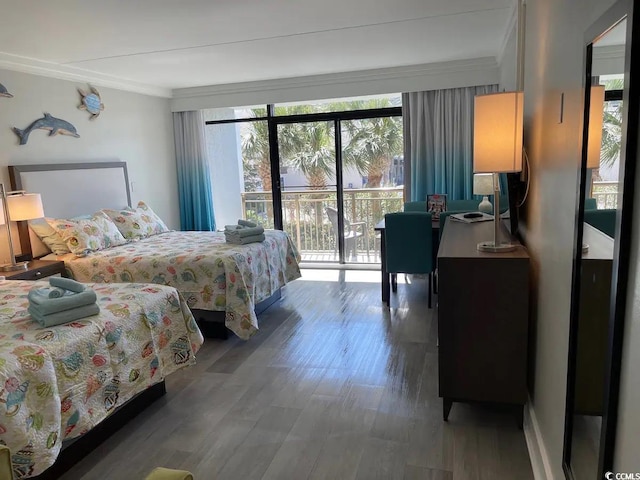 bedroom featuring access to exterior, wood-type flooring, and crown molding