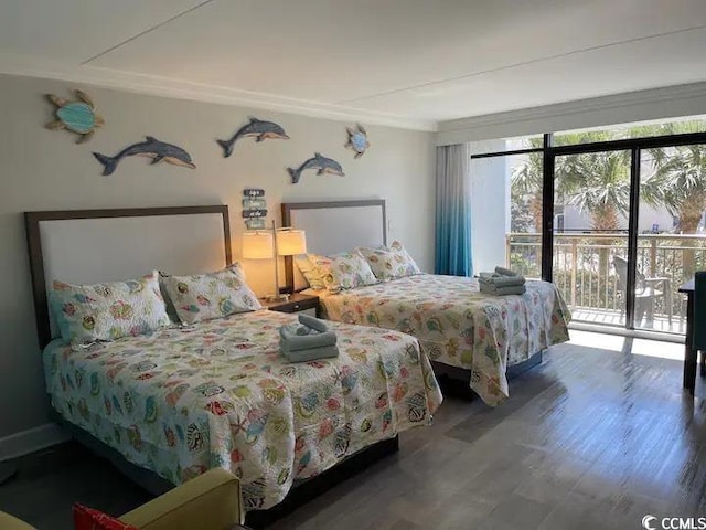 bedroom featuring access to outside, multiple windows, hardwood / wood-style floors, and ornamental molding