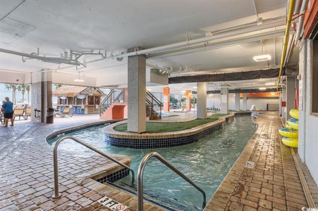 view of swimming pool with a jacuzzi