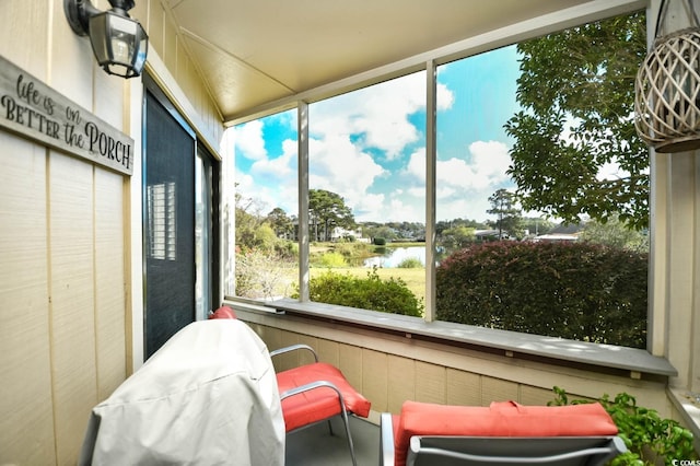 sunroom / solarium with a water view