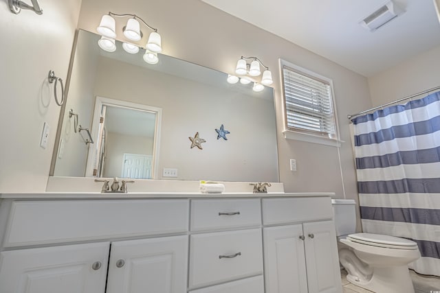 bathroom featuring tile patterned flooring, vanity, curtained shower, and toilet