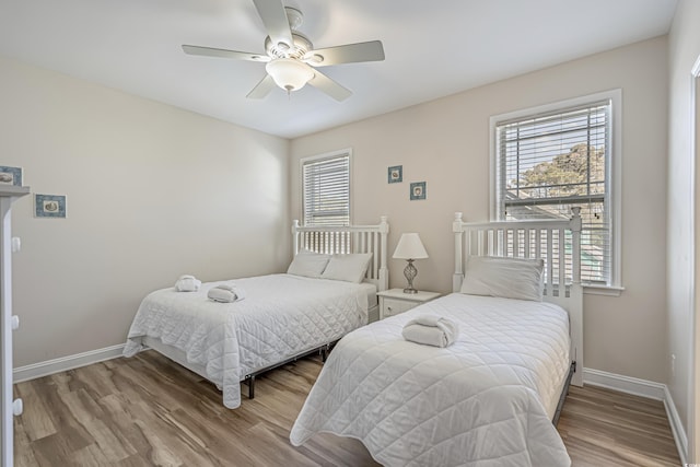 bedroom with ceiling fan and hardwood / wood-style floors