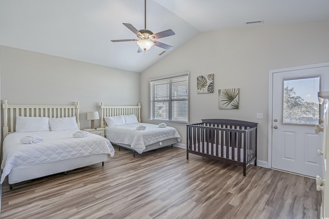 bedroom featuring light hardwood / wood-style flooring, ceiling fan, and vaulted ceiling