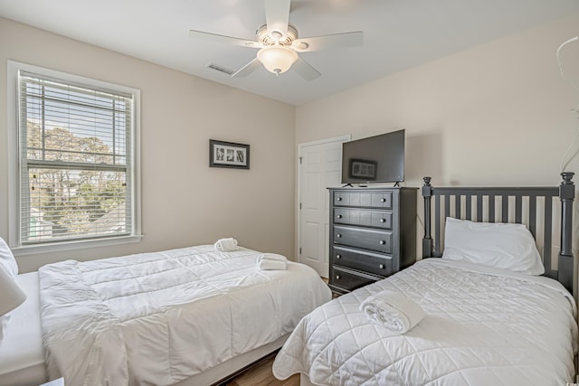 bedroom with hardwood / wood-style flooring and ceiling fan