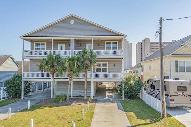 raised beach house with a carport and a front yard