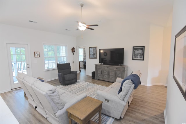 living room with high vaulted ceiling, light hardwood / wood-style flooring, and ceiling fan