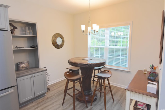 dining room with a chandelier and light hardwood / wood-style floors