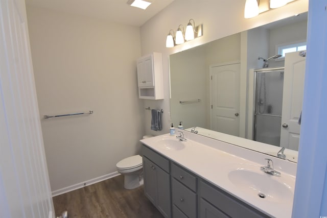 bathroom featuring vanity, wood-type flooring, and a shower with shower door