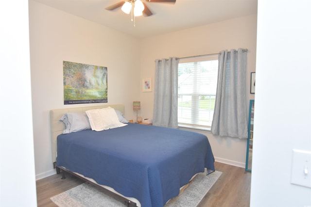 bedroom with hardwood / wood-style flooring and ceiling fan