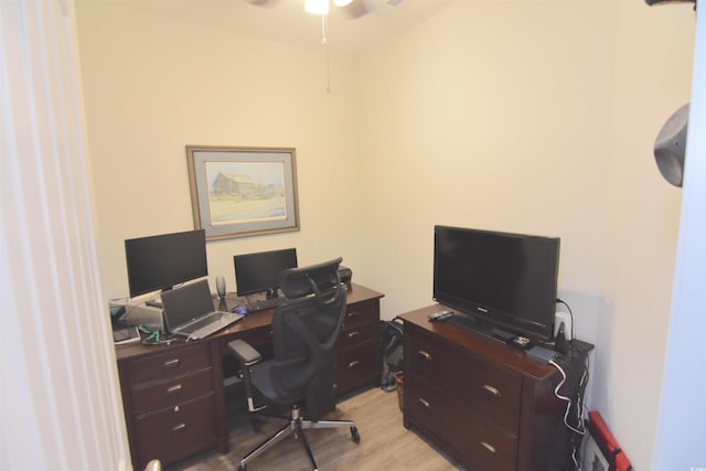 office with light hardwood / wood-style flooring and ceiling fan