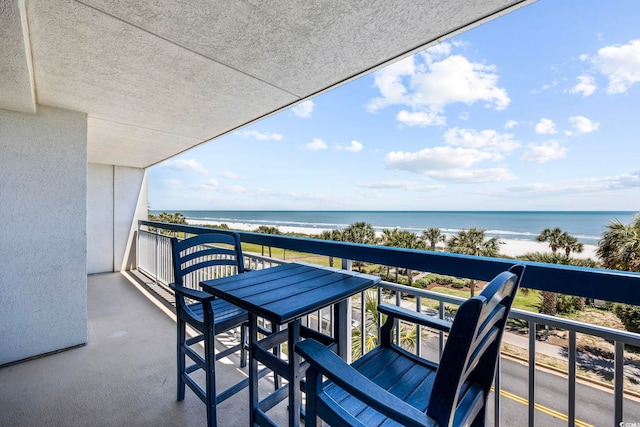 balcony with a view of the beach and a water view