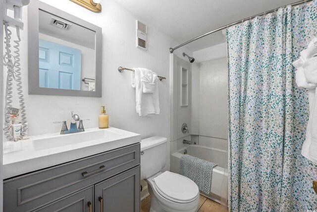 full bathroom with toilet, shower / tub combo, vanity, and tile patterned floors