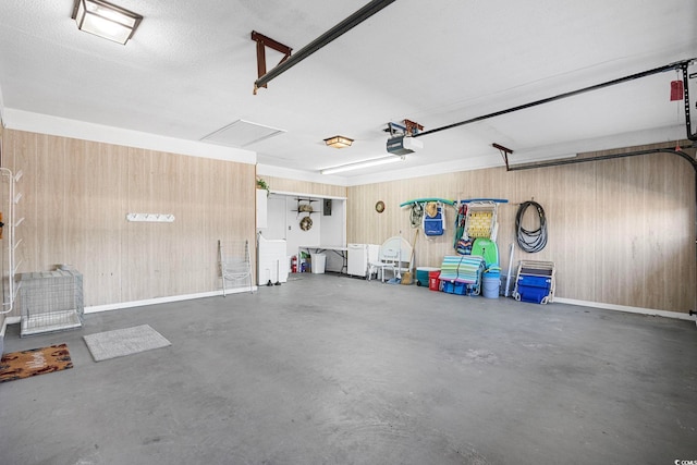 garage with a garage door opener and wooden walls