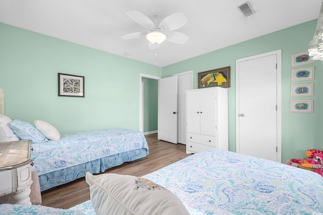 bedroom with ceiling fan and wood-type flooring