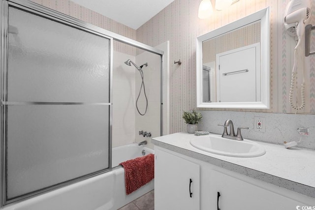 bathroom featuring enclosed tub / shower combo and vanity