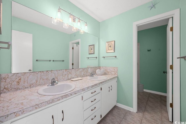 bathroom featuring tile patterned flooring, vanity, and toilet