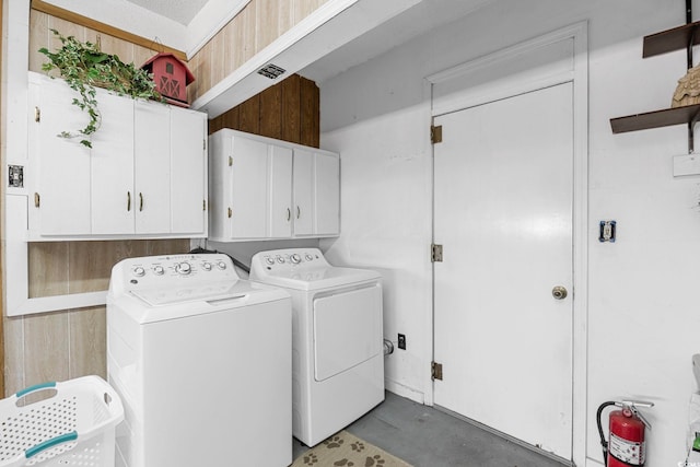 laundry room with cabinets and separate washer and dryer