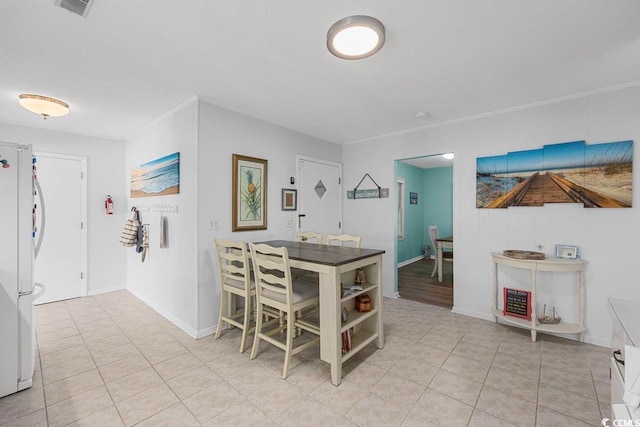 dining area with light tile patterned floors